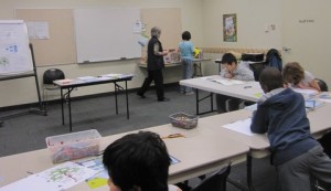 Kids building their family tree booklet at the library.